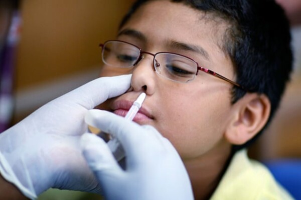 Image of a child receiving a flu vaccination