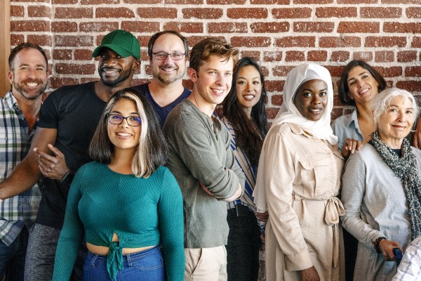 Group of people staging in front of a wall